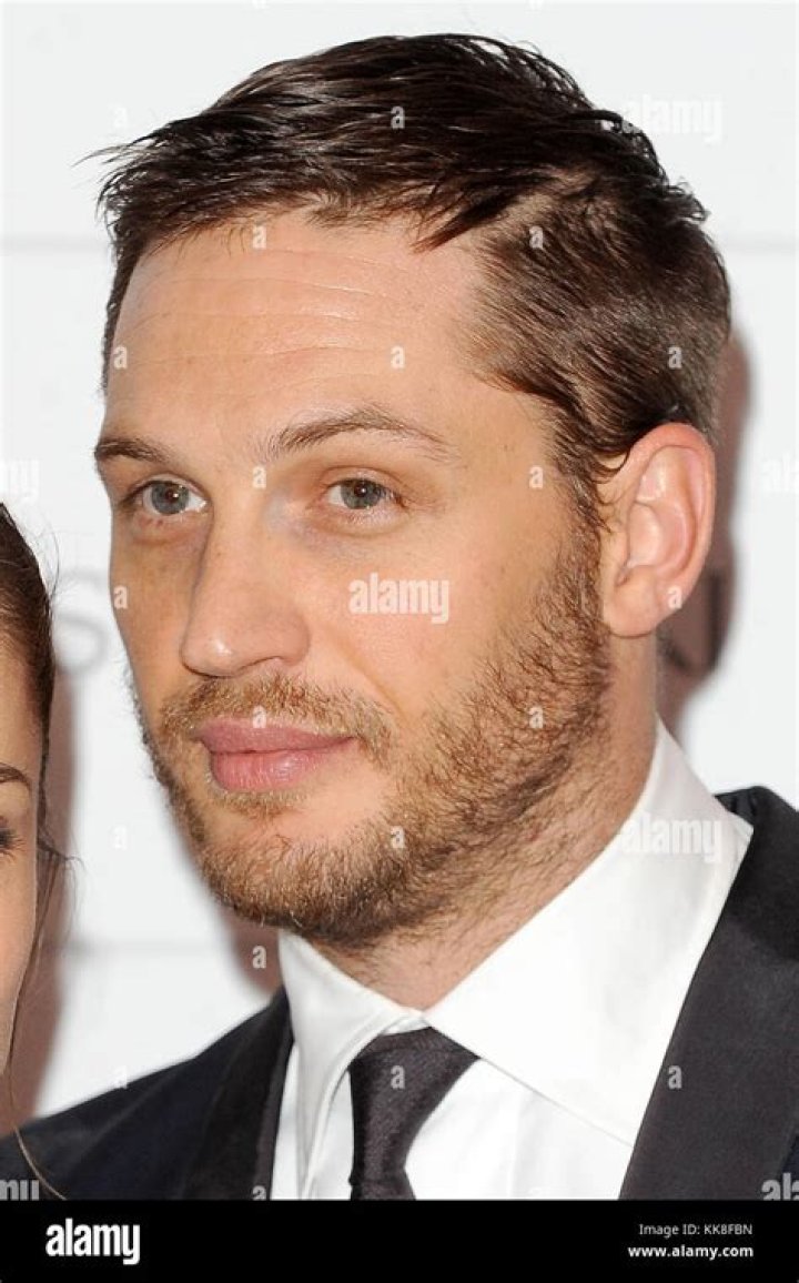 English actor Tom Hardy and his girlfriend Charlotte Riley attend the