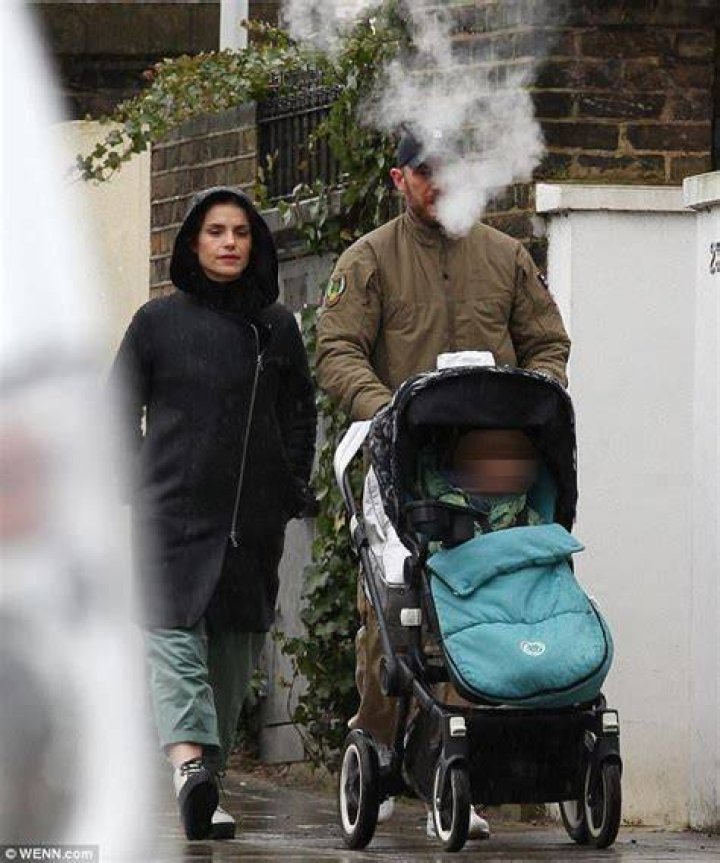 Tom Hardy braves the wet weather with wife Charlotte Riley